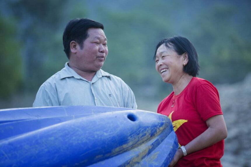 Mr De and Mrs Luot with a blue kayak