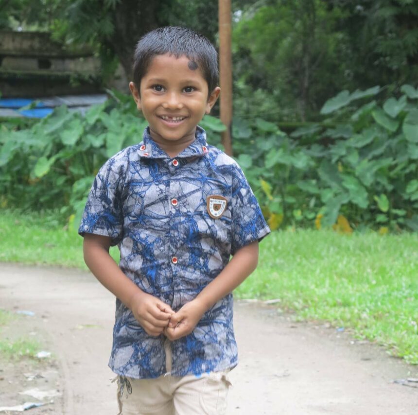 Fahim smiling and walking down a road