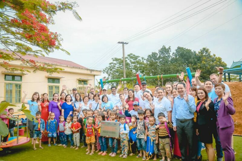 Students, Seaco volunteers, and AOP staff pose for a group photo at the newly renovated school