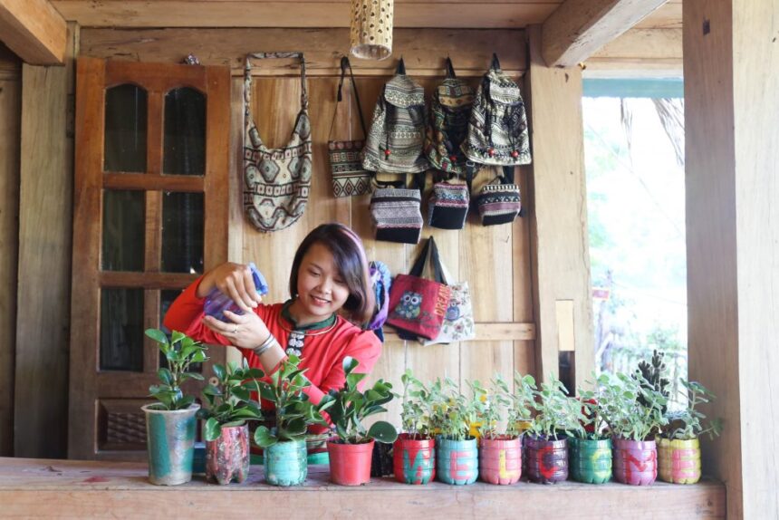 Trang watering pot plants at her homestay