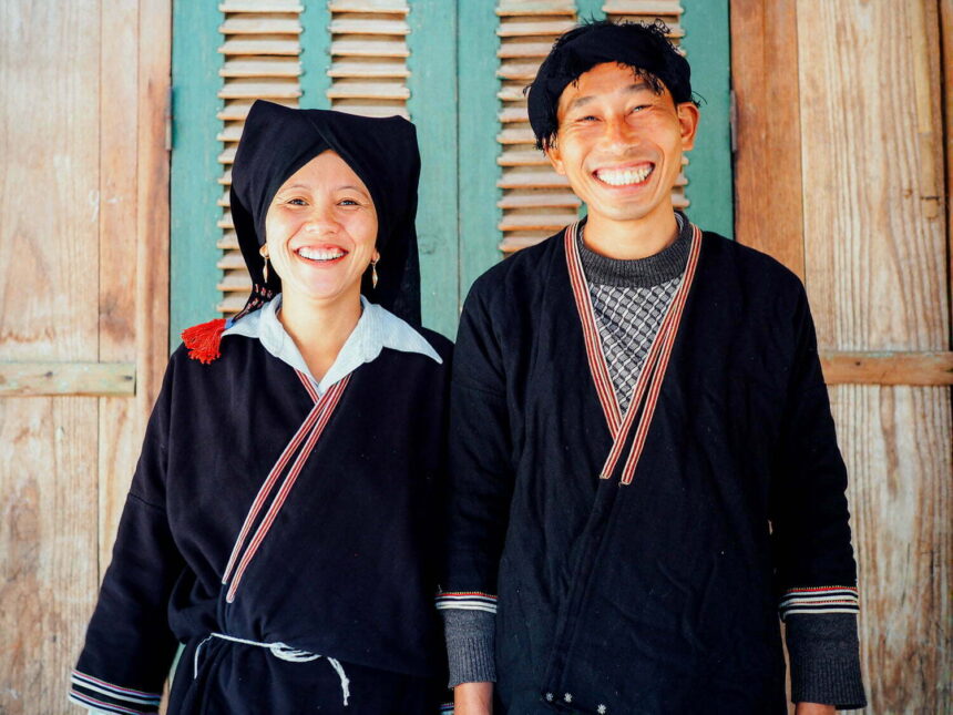 Xuan and Lan standing in front of their homestay in Da Bac, Vietnam